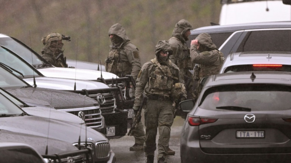 Australian police urge gunman to surrender after officers killed