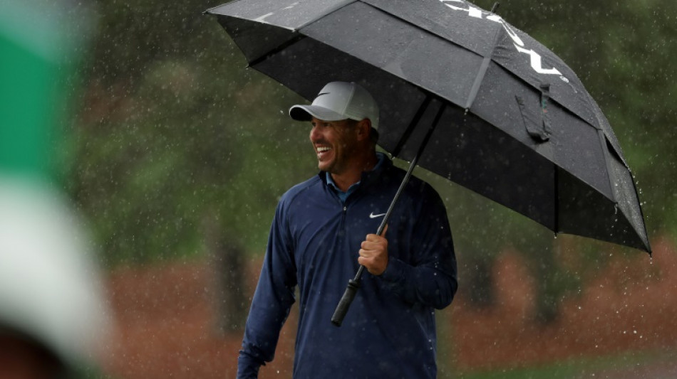 Koepka extends Masters lead before rain stops play