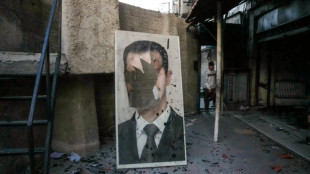 S&iacute;rios comemoram a queda de Assad na capital Damasco