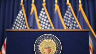 Stocks slip, dollar down as Fed meets on rates